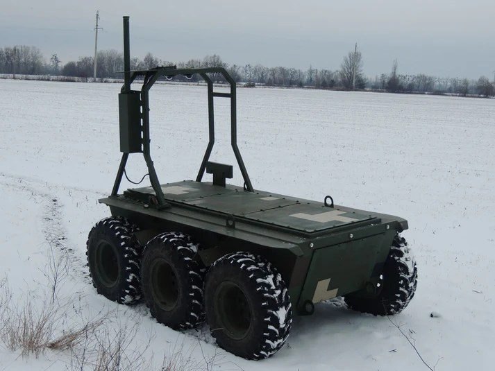RAVLYK 6x6 crossing an open snowfield in the field